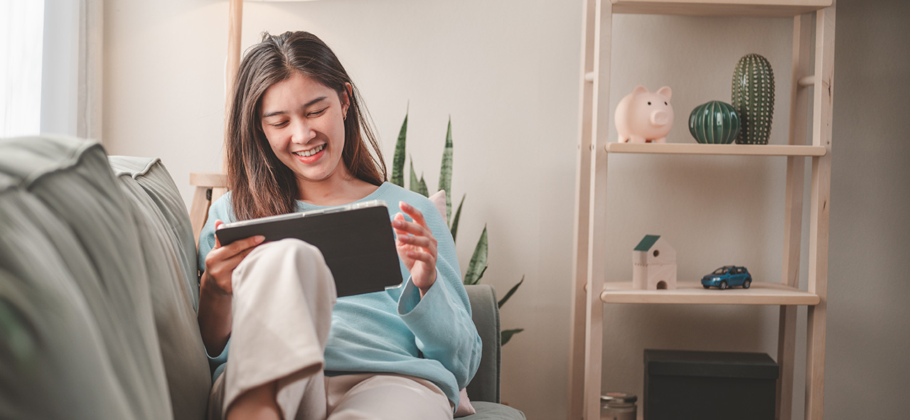 Woman,,Happy,,Home,,Lifestyle,,Sofa,,Tablet,,Online,,Sitting,,Communication,,Young.
